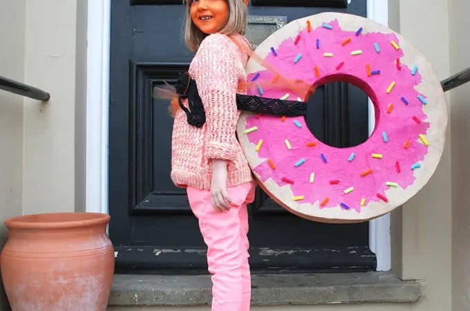 Child wearing easy Norman The Slug costume with handmade doughnut shell for World Book Day