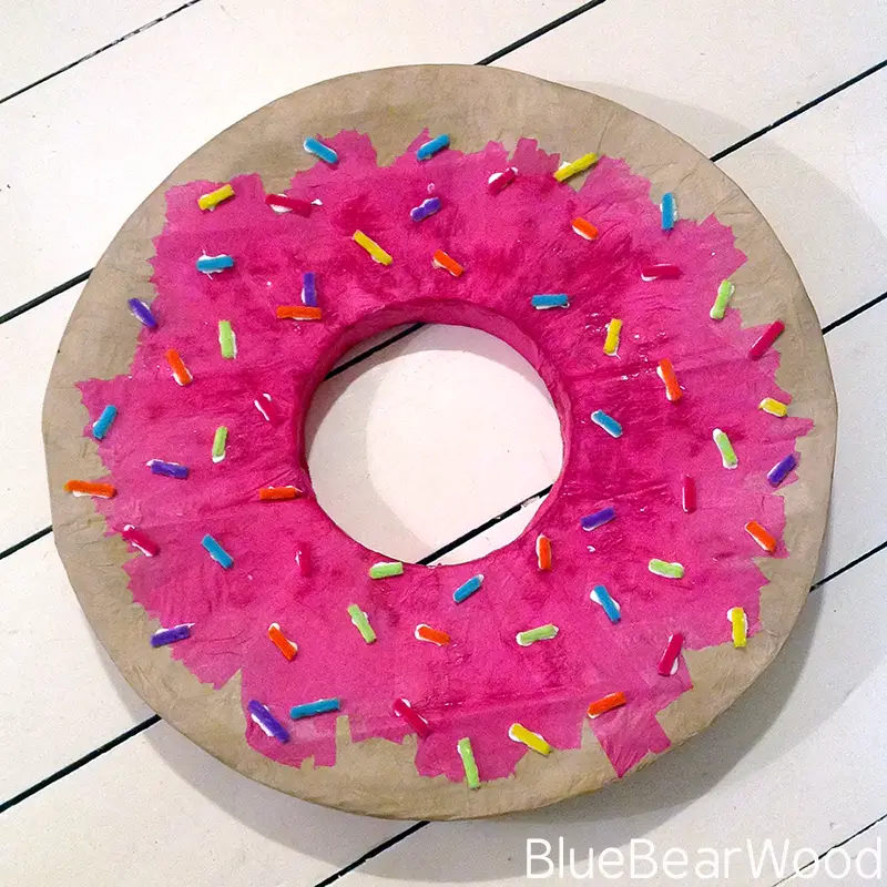 Handmade doughnut shell with pink icing and sprinkles for a Norman The Slug costume