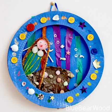 Paper plate mermaid craft for kids showing underwater collage with shells and sparkle