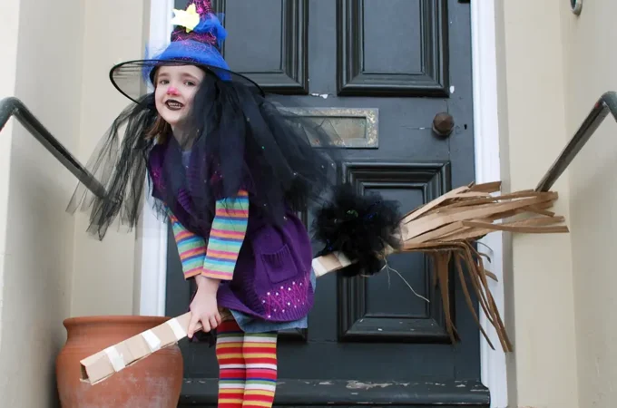 Easy Winnie The Witch Costume - Young Child On Doorstep Posing As Winnie The Witch