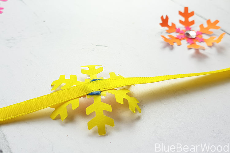 Glue Paper Snowflake Onto The Ribbon